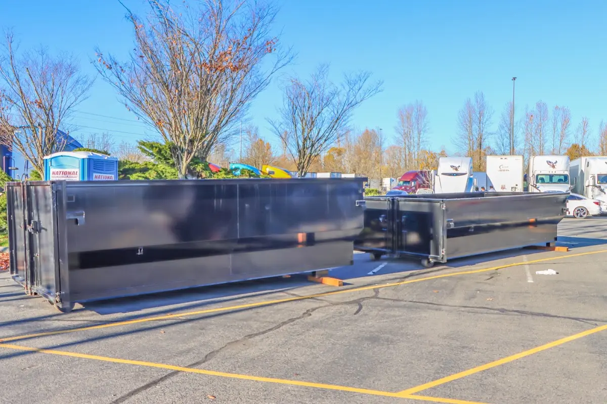 Professional dumpster rental service with roll-off container on residential driveway in Cambria